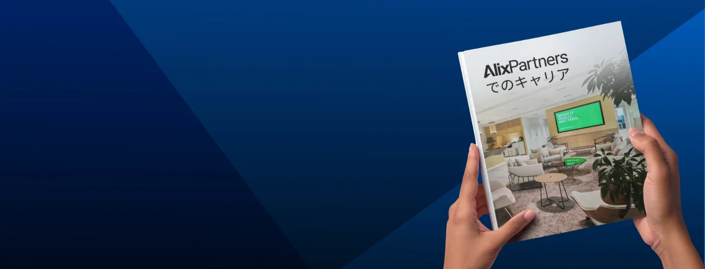 Two hands holding a Japanese AlixPartners Careers Book